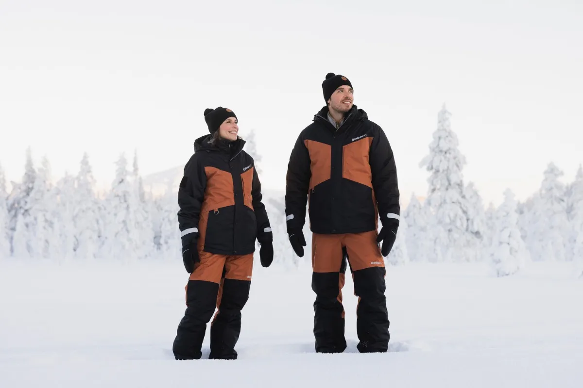Two adults in rental winter jackets and trousers in Levi